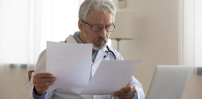 Middle aged doctor reviewing contract