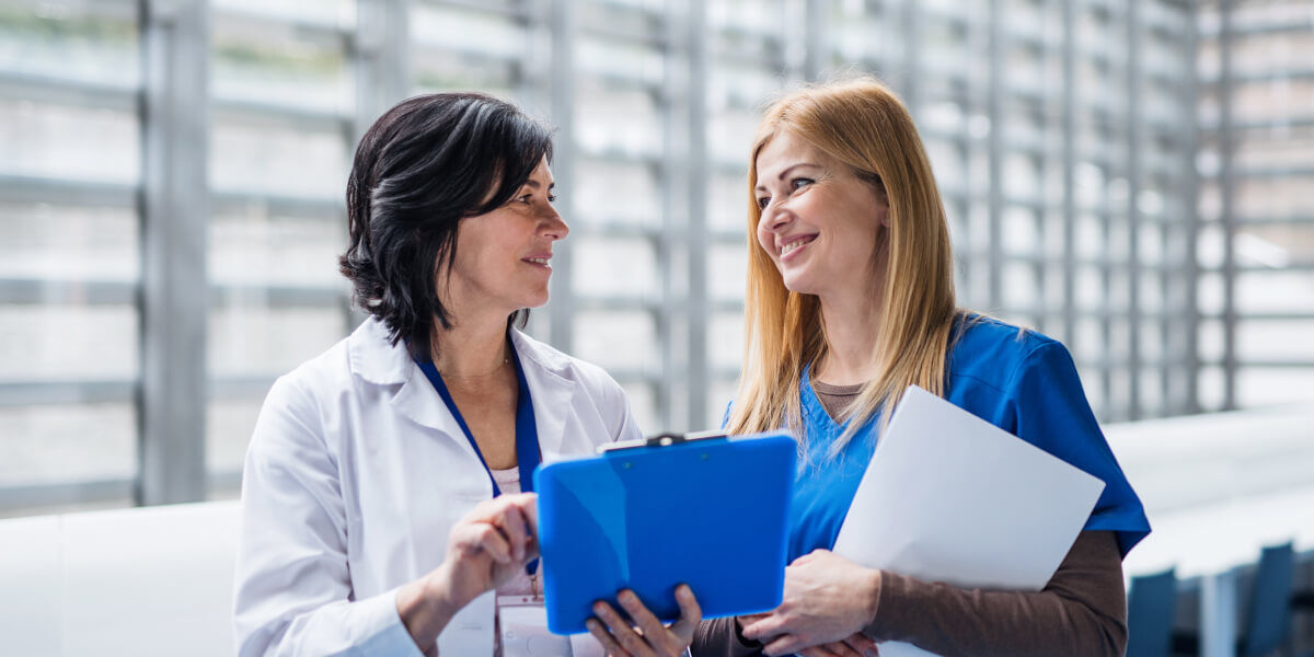 women doctors reviewing contract negotiation