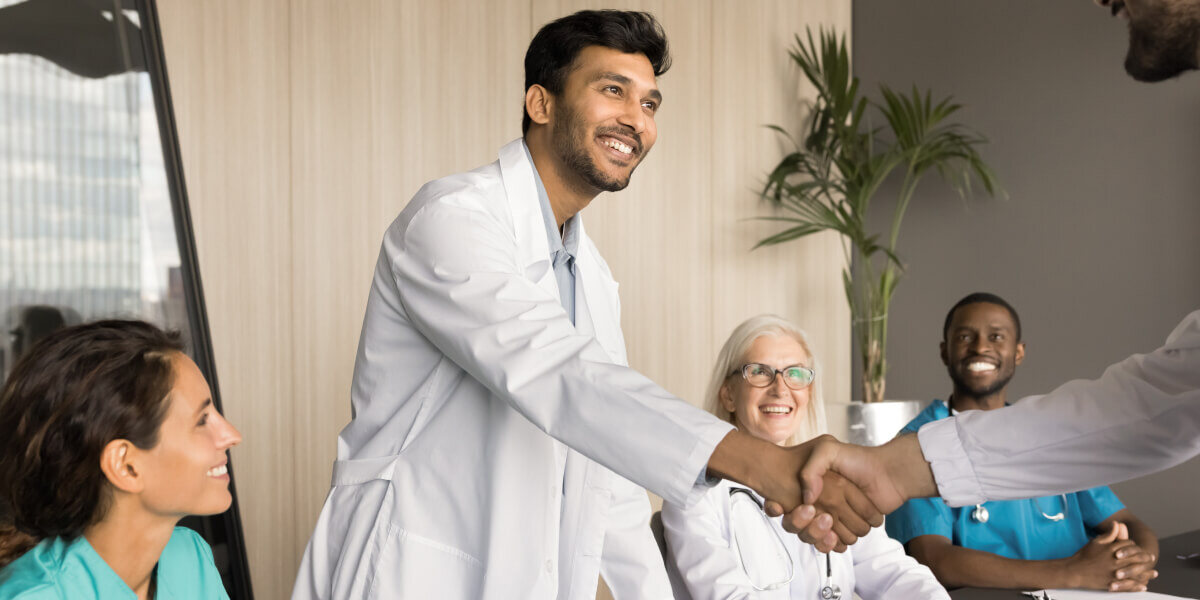 young Indian doctor shaking hands